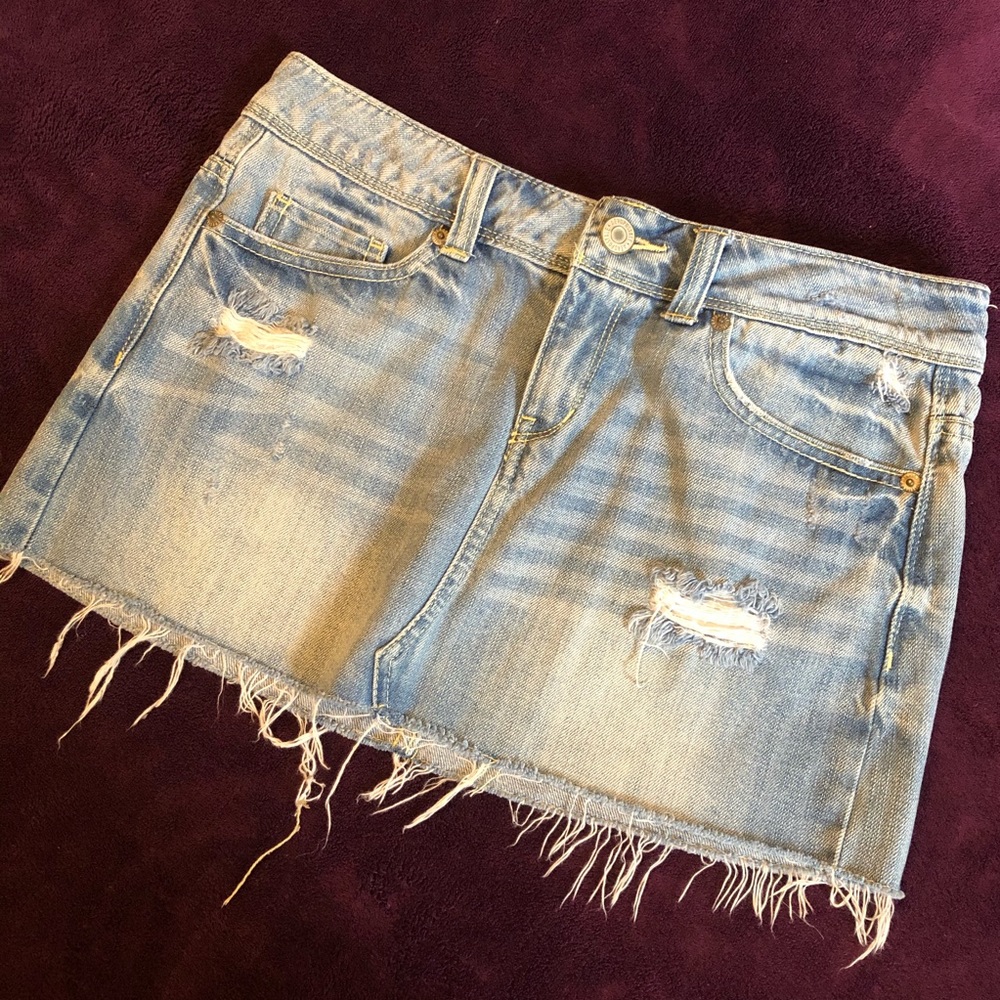Distressed light denim mini skirt